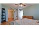 Bedroom with light teal walls, ceiling fan, and wood floors at 2901 26Th W St # 818, Bradenton, FL 34205