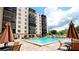 Relaxing pool area with patio furniture and building view at 2901 26Th W St # 818, Bradenton, FL 34205
