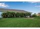 Large backyard with green grass and tropical plants at 3115 Live Oak Ln # 30, Palmetto, FL 34221