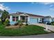 Front view of a light blue house with a two-car garage and well-maintained lawn at 3115 Live Oak Ln # 30, Palmetto, FL 34221