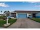 Front view of a light blue house with a two-car garage and a mailbox at 3115 Live Oak Ln # 30, Palmetto, FL 34221