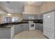 Modern kitchen with gray cabinets, granite counters and white appliances at 3115 Live Oak Ln # 30, Palmetto, FL 34221