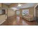 Living room with hardwood floors, a beige couch and access to the kitchen at 3115 Live Oak Ln # 30, Palmetto, FL 34221