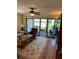 Living room with lake view and hardwood floors at 3500 El Conquistador Pkwy # 331, Bradenton, FL 34210