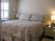 Bedroom with floral bedding and wicker nightstand at 3820 Ironwood Ln # 106-I, Bradenton, FL 34209