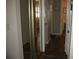 Hallway with mirrored closet doors and wood flooring at 3820 Ironwood Ln # 106-I, Bradenton, FL 34209