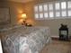 Bedroom with a queen-size bed and plantation shutters at 3820 Ironwood Ln # 106-I, Bradenton, FL 34209