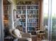 Sunroom with built-in bookcase and comfortable seating at 3820 Ironwood Ln # 106-I, Bradenton, FL 34209