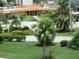 Community entrance with lush landscaping and palm trees at 3820 Ironwood Ln # 106-I, Bradenton, FL 34209