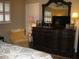 Bright bedroom with a dresser, chair, and large mirror at 3820 Ironwood Ln # 106-I, Bradenton, FL 34209