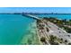 Aerial view of a coastal city with bridge, ocean, and waterfront properties at 4245 Hearthstone Dr, Sarasota, FL 34238