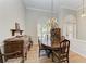 Formal dining room featuring hardwood floors, a chandelier, and antique furniture at 4245 Hearthstone Dr, Sarasota, FL 34238