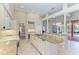 Gourmet kitchen with granite island, breakfast bar, and pool view at 4245 Hearthstone Dr, Sarasota, FL 34238