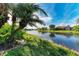 Serene waterfront view showcasing canal, palm trees, and homes at 4245 Hearthstone Dr, Sarasota, FL 34238