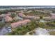 Aerial view of community with lake and lush landscaping at 4990 Baraldi Cir # 211, Sarasota, FL 34235