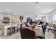 Open floor plan connecting kitchen and living room with a large dining table at 5058 Granite Dust Pl, Palmetto, FL 34221