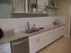 Modern kitchen with white cabinets and granite countertops at 5242 Parisienne Pl # 201, Sarasota, FL 34238