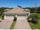 Tan house with three car garage and nicely landscaped lawn at 5450 Fairfield Blvd, Bradenton, FL 34203