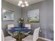 Small dining area with glass table and white chairs at 6079 Coral Way, Bradenton, FL 34207