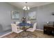 Small dining area with glass table and white chairs at 6079 Coral Way, Bradenton, FL 34207