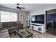 Bright living room with sectional sofa, large TV, and access to another room at 6079 Coral Way, Bradenton, FL 34207