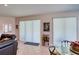 Bright dining area with glass table and access to backyard patio at 8115 Stirling Falls Cir, Sarasota, FL 34243