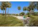 Relaxing waterfront view with seating area and lush landscaping at 8115 Stirling Falls Cir, Sarasota, FL 34243