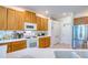 Well-equipped kitchen with wood cabinets and stainless steel appliances at 8115 Stirling Falls Cir, Sarasota, FL 34243