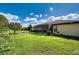 Large backyard with grassy area and screened patio at 8115 Stirling Falls Cir, Sarasota, FL 34243