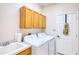 Laundry room with washer, dryer, and cabinets at 8115 Stirling Falls Cir, Sarasota, FL 34243