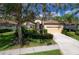 Single-Gathering home with a two-car garage and lush landscaping at 8115 Stirling Falls Cir, Sarasota, FL 34243