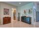 Elegant entryway with decorative console tables and art at 8115 Stirling Falls Cir, Sarasota, FL 34243
