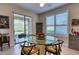 Casual dining room with round glass table near sliding doors at 8115 Stirling Falls Cir, Sarasota, FL 34243