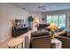 Comfortable living room with leather sofas and large TV at 8115 Stirling Falls Cir, Sarasota, FL 34243