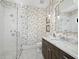 Charming bathroom with bird wallpaper, marble countertops, and a glass shower at 8413 9Th Nw Ave, Bradenton, FL 34209