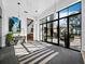 Sunroom features a striped rug, marble console table, and views to the patio at 8413 9Th Nw Ave, Bradenton, FL 34209