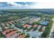 Aerial view of upscale community with lake and lush landscape at 11414 Hawick Pl, Lakewood Ranch, FL 34202