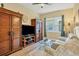 Relaxing den with comfortable seating and built in wooden cabinets at 12706 Lake Silver Ave, Bradenton, FL 34211