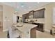Modern kitchen with dark cabinetry, quartz countertops, and stainless steel appliances at 12706 Lake Silver Ave, Bradenton, FL 34211