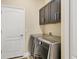 Convenient laundry room with washer, dryer, and storage cabinets at 12706 Lake Silver Ave, Bradenton, FL 34211