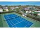 Blue tennis court with green perimeter fencing at 12706 Lake Silver Ave, Bradenton, FL 34211