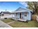 Charming light blue house with a covered porch and landscaped yard at 1305 11Th W Ave, Bradenton, FL 34205