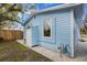 Light blue house exterior with white trim, a shed, and a gravel area at 1305 11Th W Ave, Bradenton, FL 34205