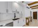 White kitchen with farmhouse sink and stainless steel dishwasher at 1305 11Th W Ave, Bradenton, FL 34205