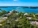 Bird's-eye view of a house nestled amongst trees near the water at 1331 Quail Dr, Sarasota, FL 34231