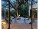 Private backyard oasis with a large tree and hammock at 1331 Quail Dr, Sarasota, FL 34231