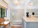 Spa-like bathroom with double vanity, walk-in shower, and concrete floors at 1331 Quail Dr, Sarasota, FL 34231