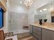 Spa-like bathroom with double vanity, walk-in shower, and chandelier at 1331 Quail Dr, Sarasota, FL 34231
