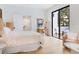 Bedroom with light pink bedding, private balcony, and a small workspace at 1331 Quail Dr, Sarasota, FL 34231