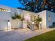 Modern home with a pink door and well-lit entrance at 1331 Quail Dr, Sarasota, FL 34231